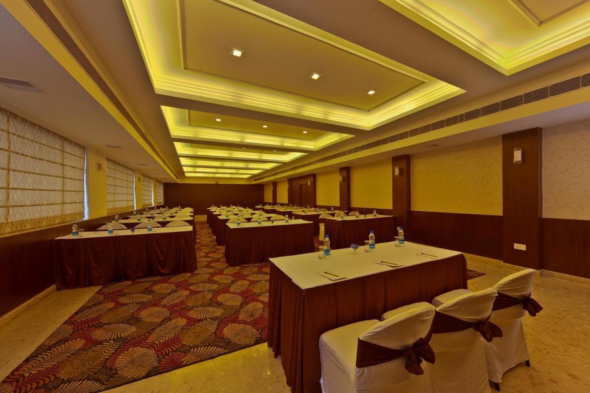 a banquet hall with tables and chairs in a room at Hotel Hindusthan International, Kolkata in Kolkata