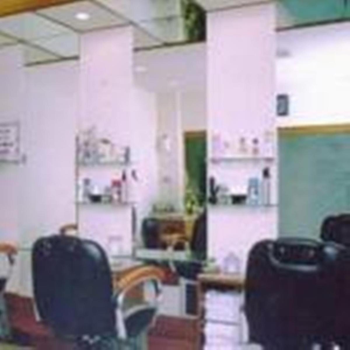 a room with chairs and a table in a room at Hotel Hindusthan International, Kolkata in Kolkata