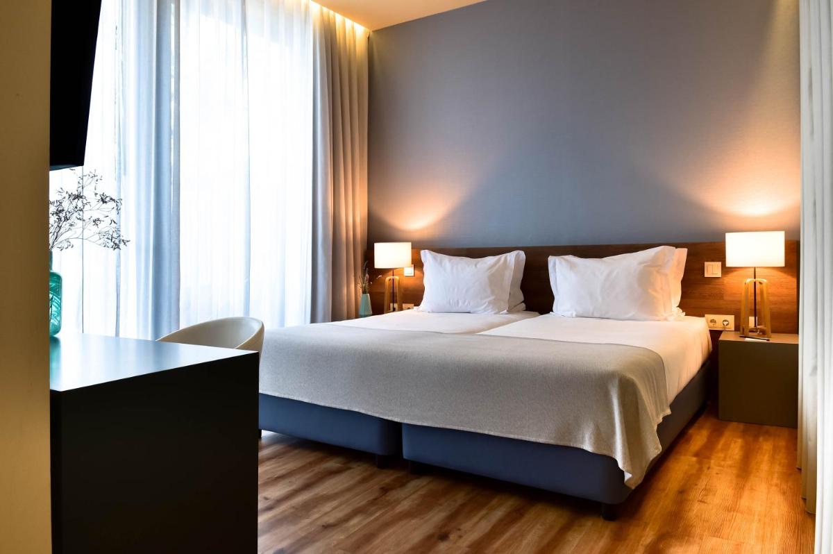 Uma cama ou camas num quarto em The Prime Energize Hotel & SPA - Algarve