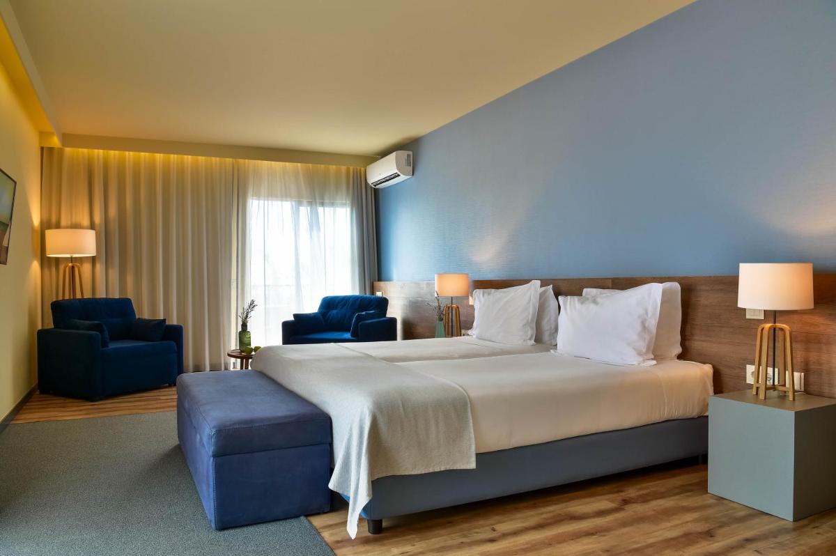 Uma cama ou camas num quarto em The Prime Energize Hotel & SPA - Algarve