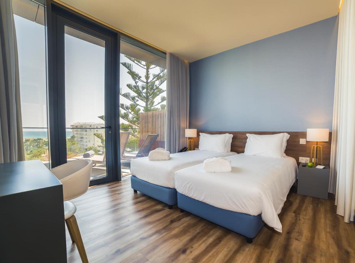 Uma cama ou camas num quarto em The Prime Energize Hotel & SPA - Algarve