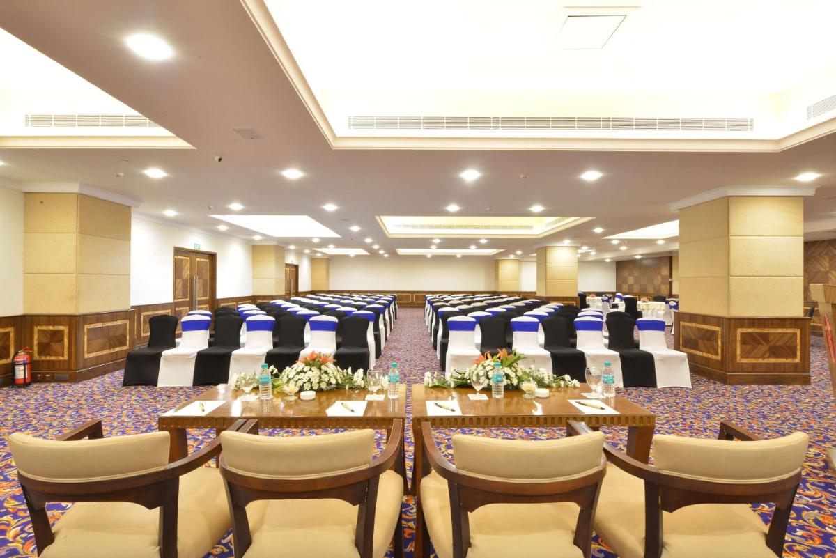 a conference room with tables and chairs in it at Ramada Plaza Chennai in Chennai