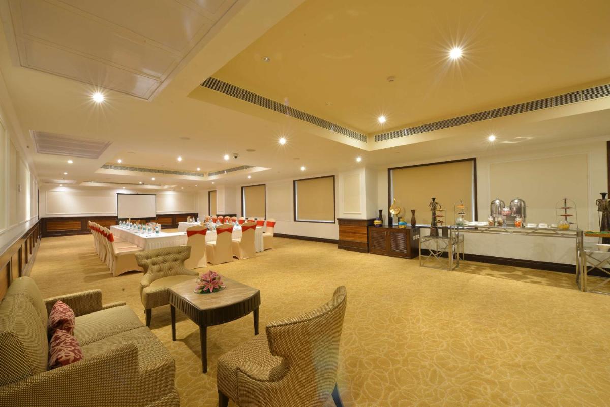 a large room with chairs and tables and a classroom at Ramada Plaza Chennai in Chennai