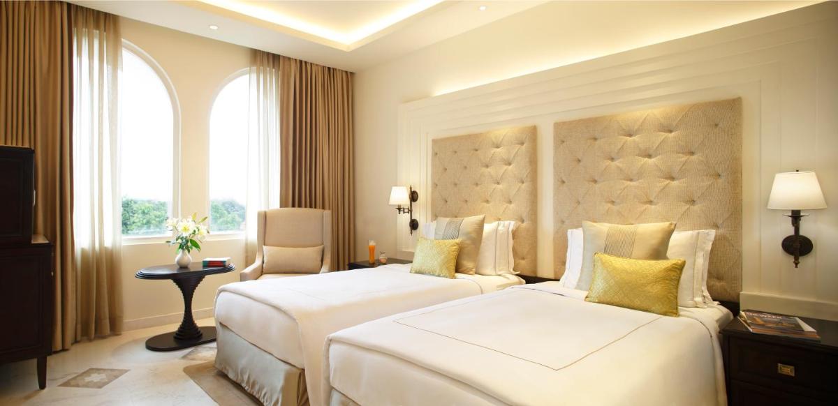 a hotel room with two beds and a window at Taj Ganges Varanasi in Varanasi