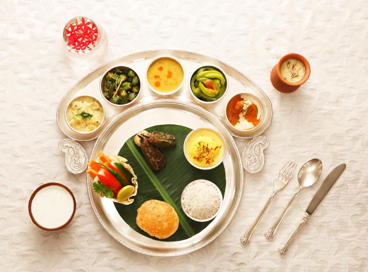 a plate of food on a table with food at Taj Ganges Varanasi in Varanasi