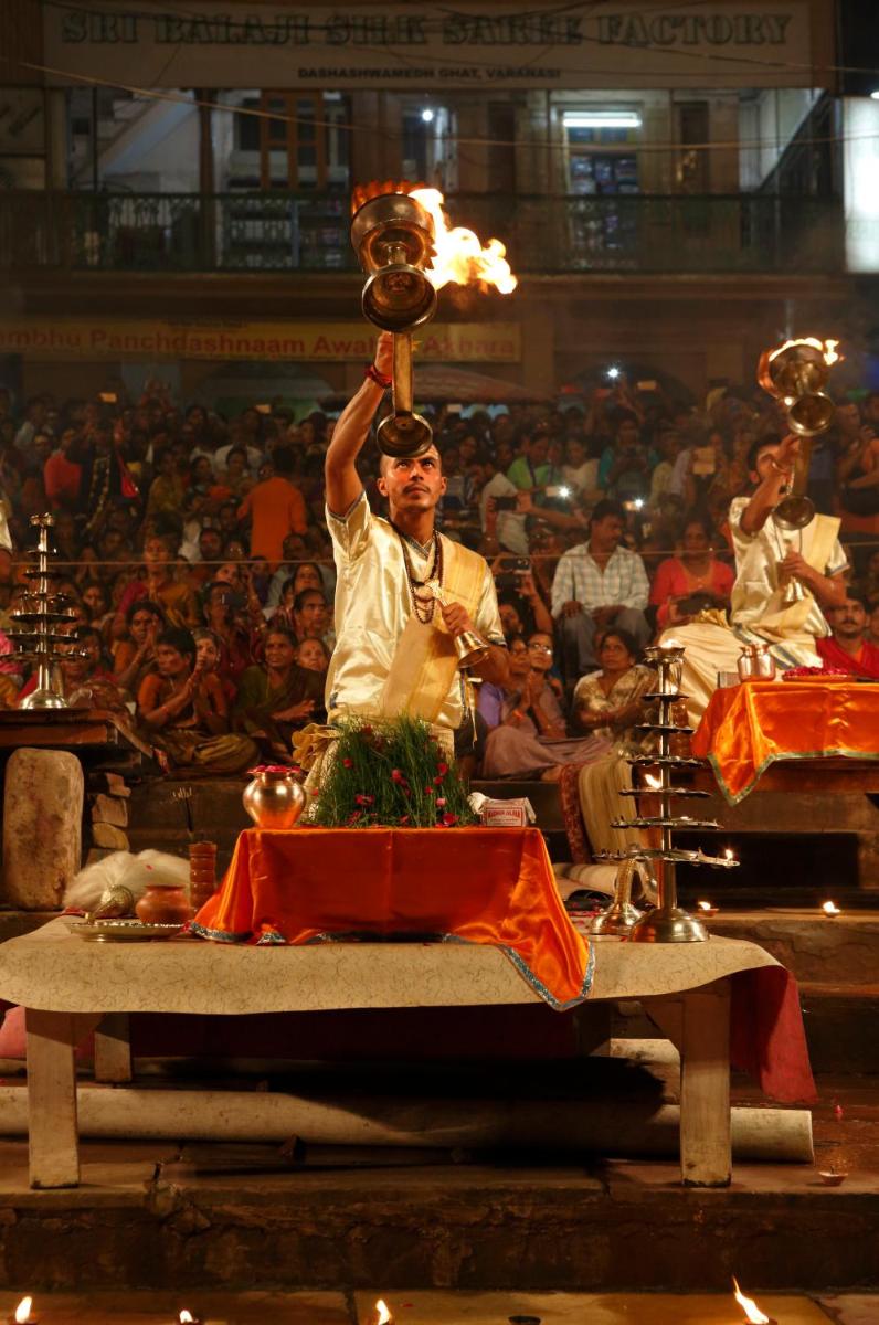 a man holding up a trophy in front of a crowd at Taj Ganges Varanasi in Varanasi