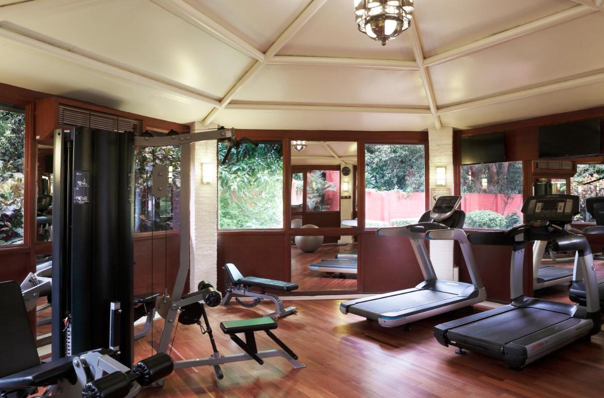 a gym with several exercise equipment in a room at Taj Ganges Varanasi in Varanasi