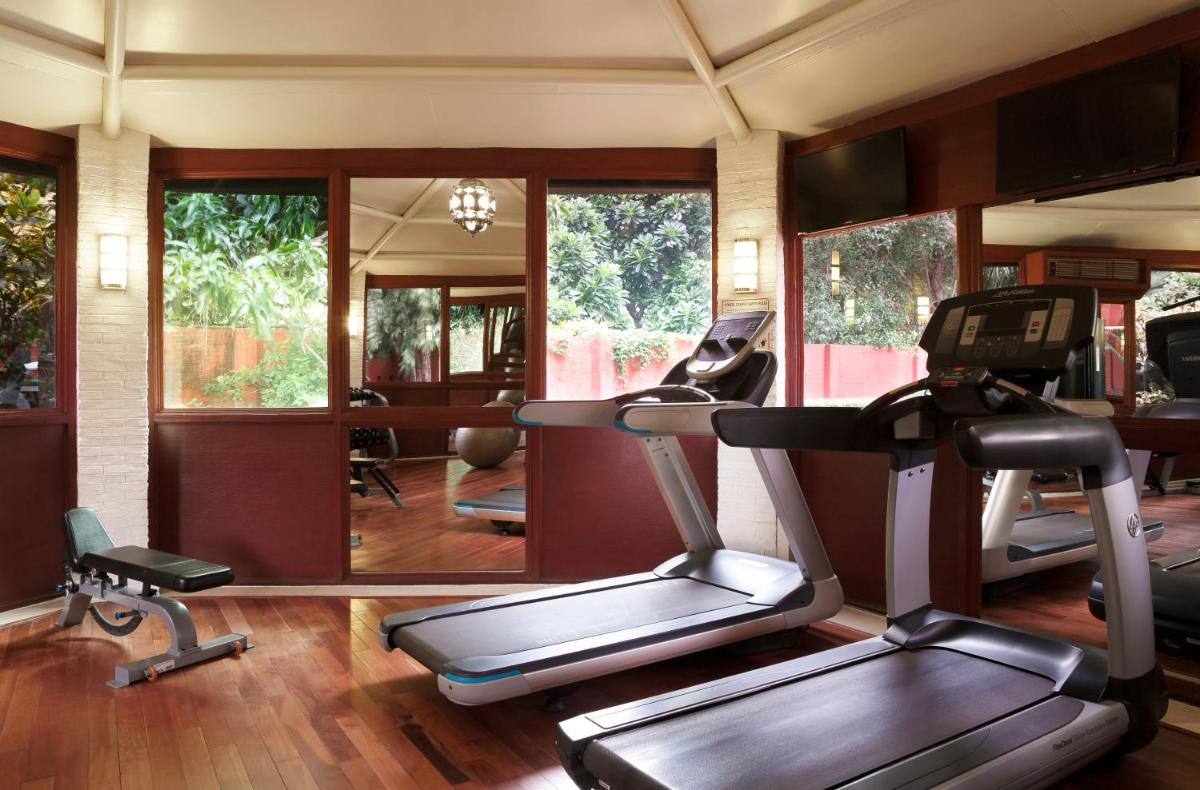 a gym with two treadmills and a treadmill at Taj Ganges Varanasi in Varanasi