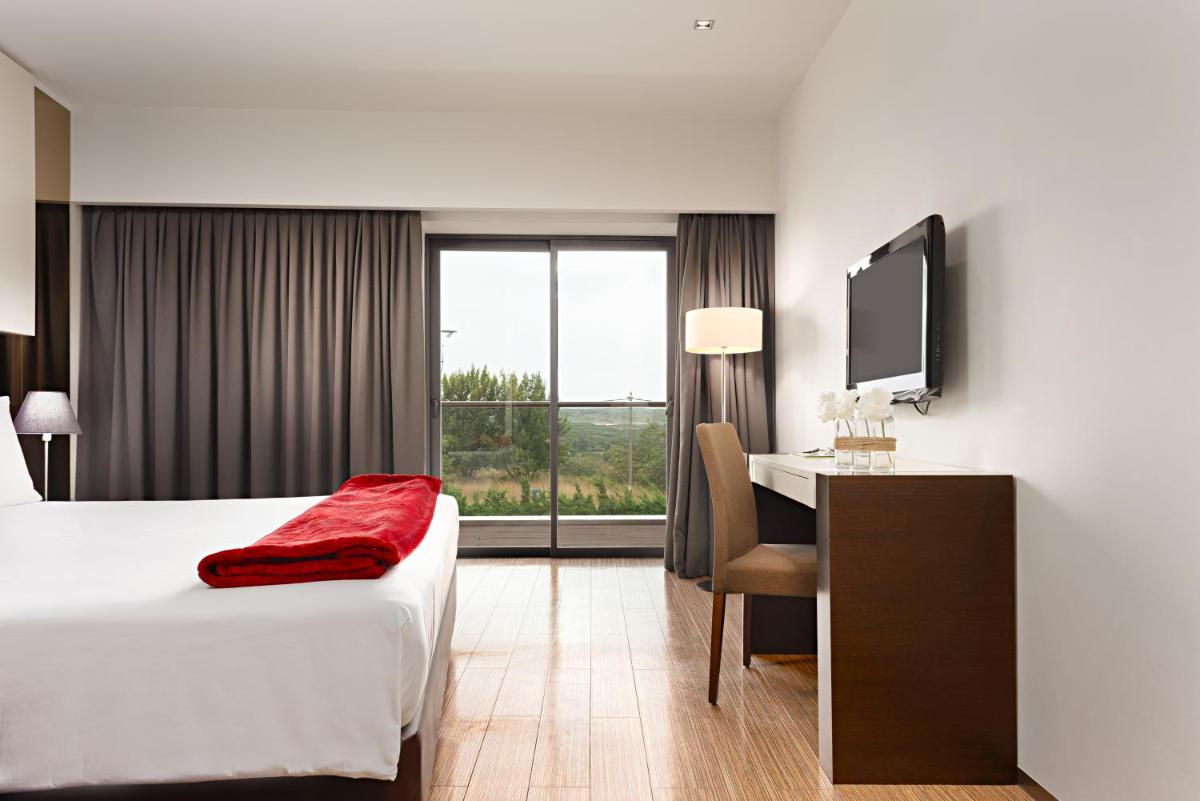 Uma cama ou camas num quarto em Hotel dos Zimbros