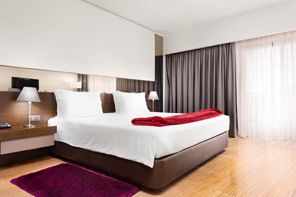 Uma cama ou camas num quarto em Hotel dos Zimbros