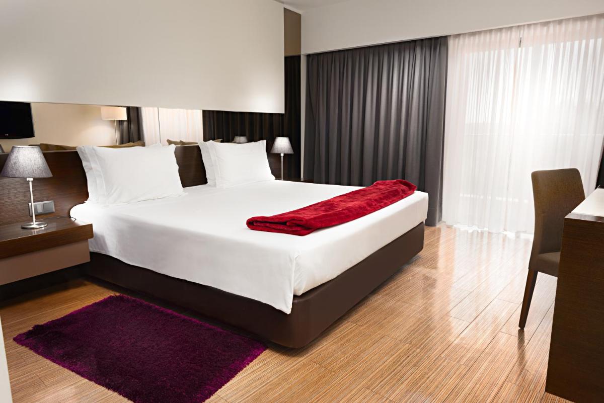 Uma cama ou camas num quarto em Hotel dos Zimbros