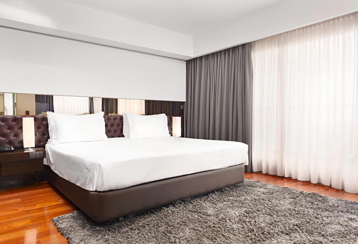 Uma cama ou camas num quarto em Hotel dos Zimbros