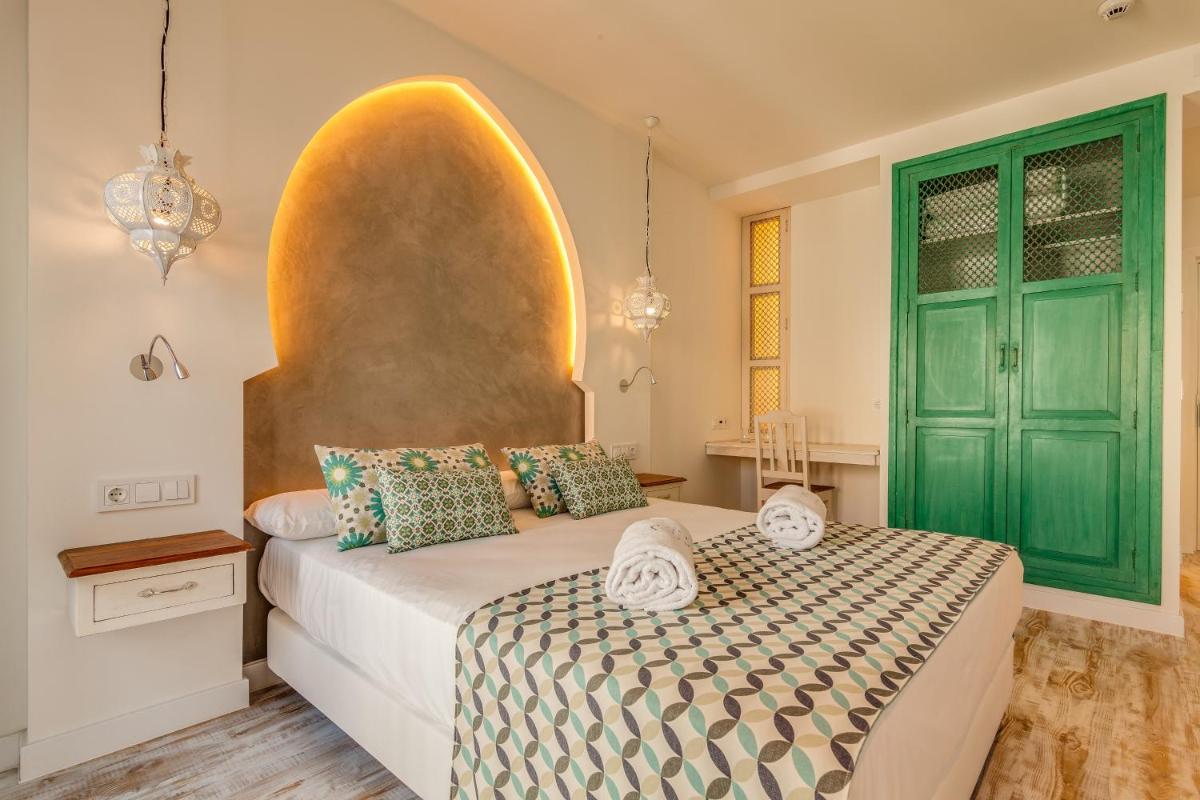 Cama o camas de una habitación en La Residencia Puerto Hotel & Spa