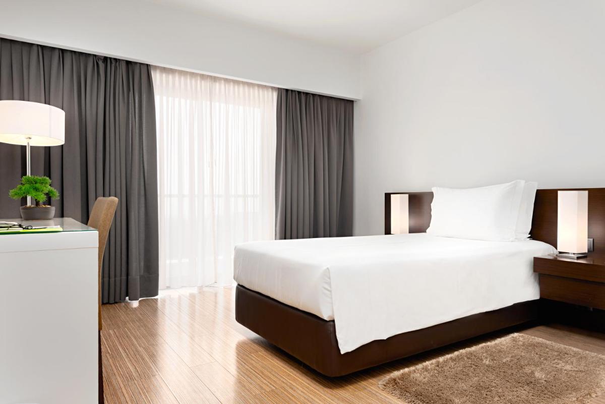 Uma cama ou camas num quarto em Hotel dos Zimbros