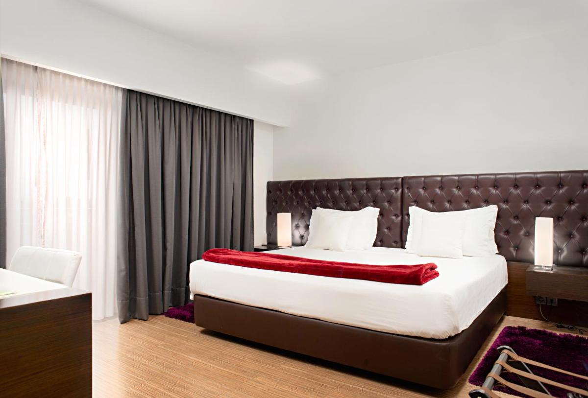 Uma cama ou camas num quarto em Hotel dos Zimbros