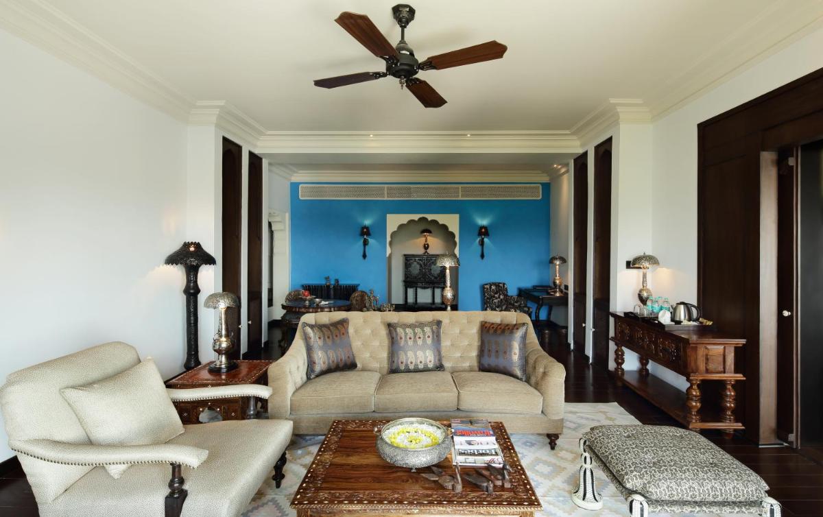 a living room with a couch and a ceiling fan at Fairmont Jaipur in Jaipur