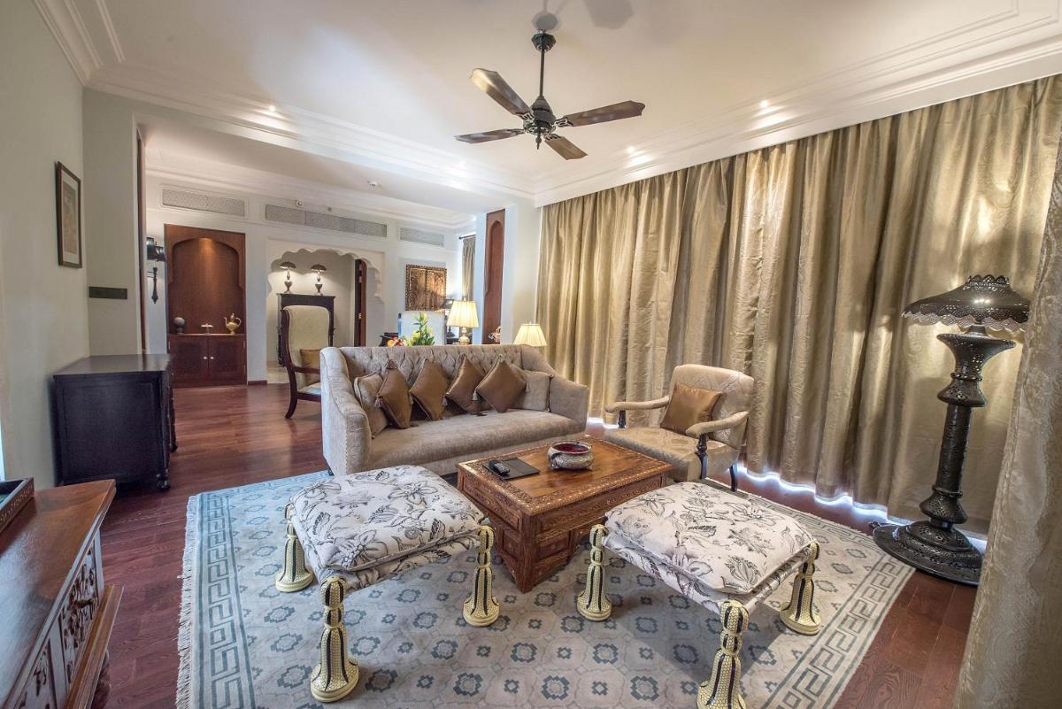 a living room with a couch and a table at Fairmont Jaipur in Jaipur