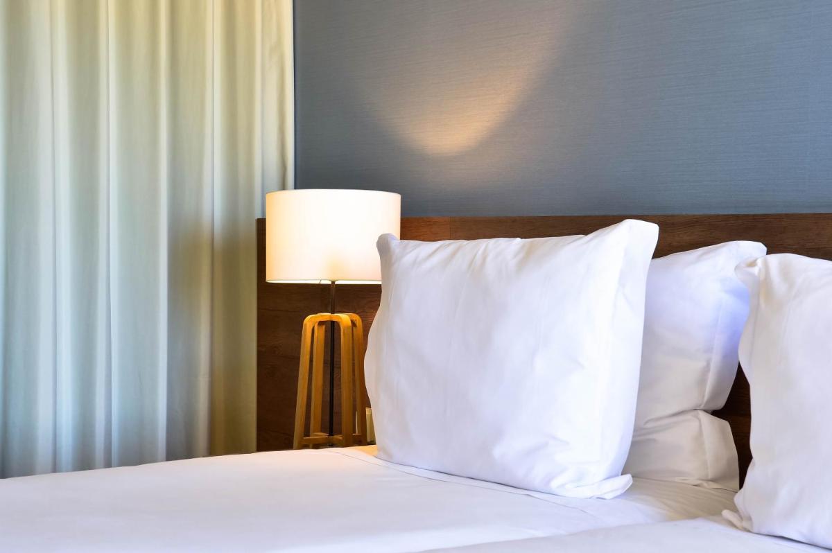 Uma cama ou camas num quarto em The Prime Energize Hotel & SPA - Algarve