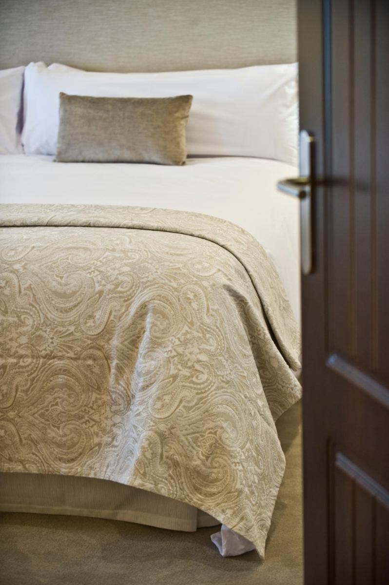 Cama o camas de una habitación en Hotel La Caminera Club de Campo