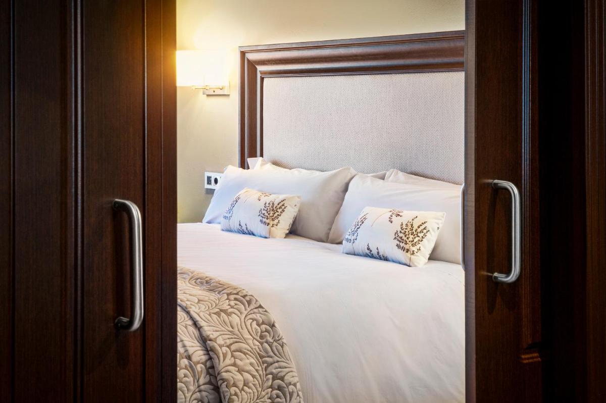 Cama o camas de una habitación en Hotel La Caminera Club de Campo