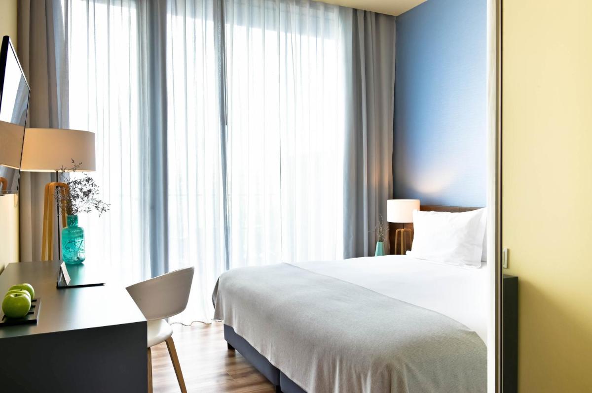 Uma cama ou camas num quarto em The Prime Energize Hotel & SPA - Algarve