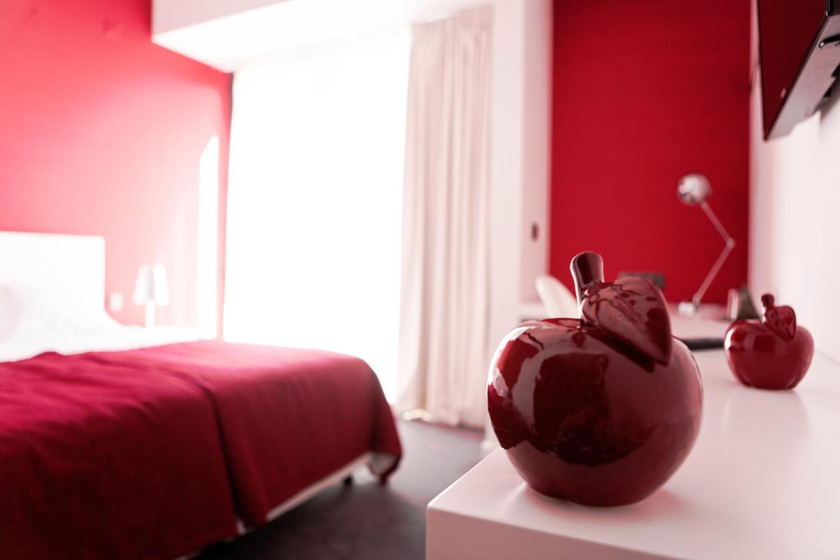 Uma cama ou camas num quarto em Real Abadia, Congress & Spa Hotel
