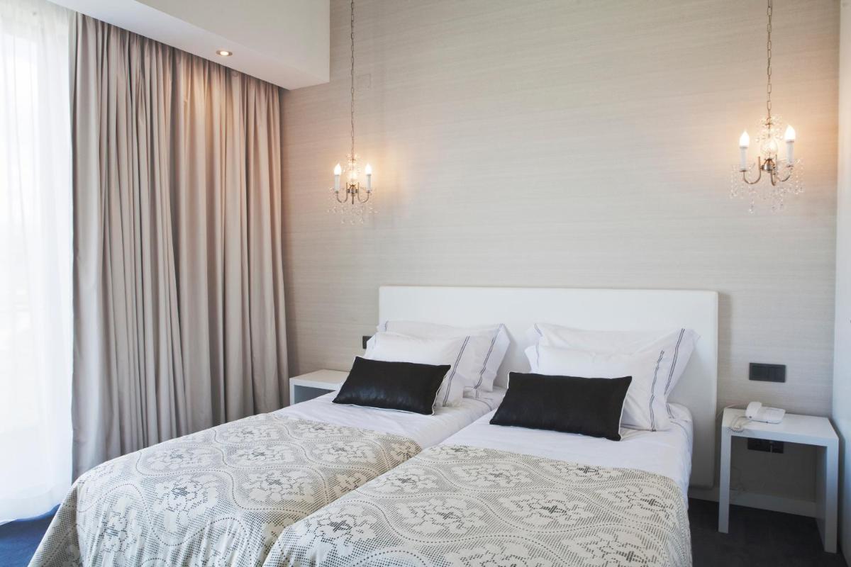 Uma cama ou camas num quarto em Real Abadia, Congress & Spa Hotel