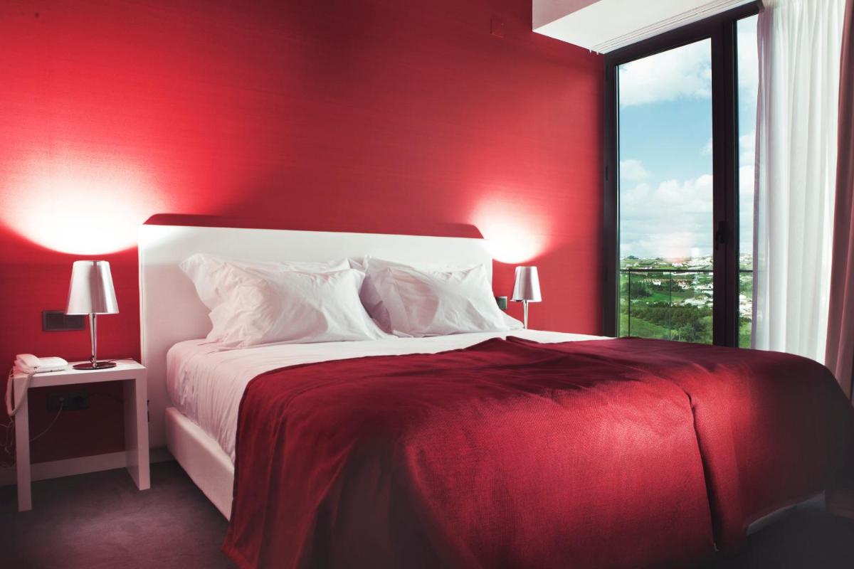 Uma cama ou camas num quarto em Real Abadia, Congress & Spa Hotel