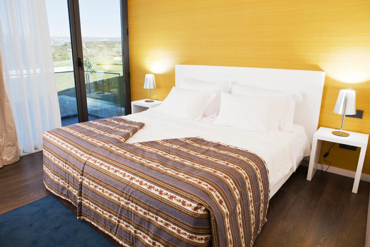 Uma cama ou camas num quarto em Real Abadia, Congress & Spa Hotel