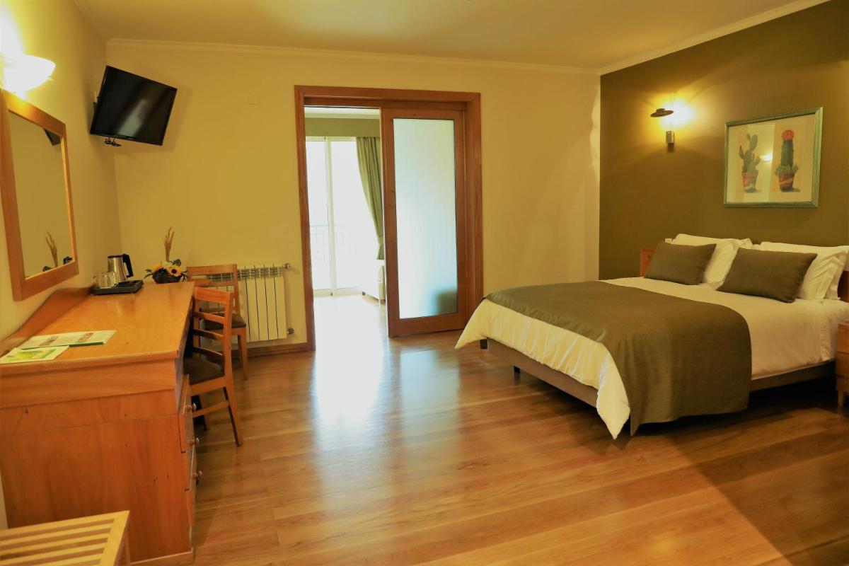 Uma cama ou camas num quarto em Eira do Serrado - Hotel & Spa