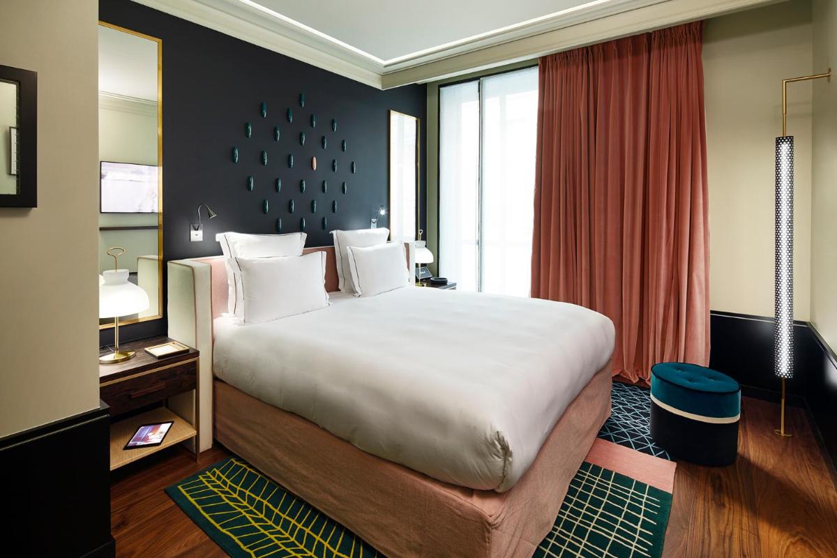 Un ou plusieurs lits dans un hébergement de l'établissement Le Roch Hotel & Spa