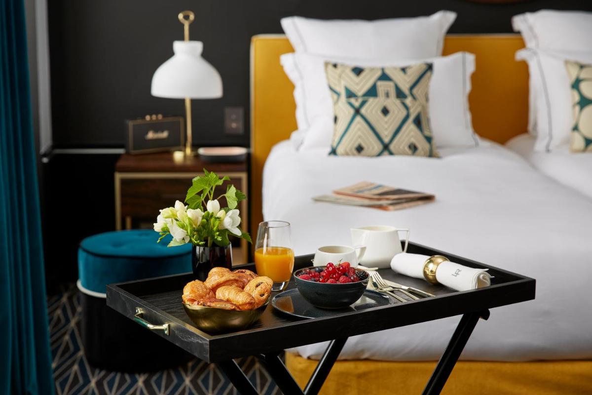 Un ou plusieurs lits dans un hébergement de l'établissement Le Roch Hotel & Spa