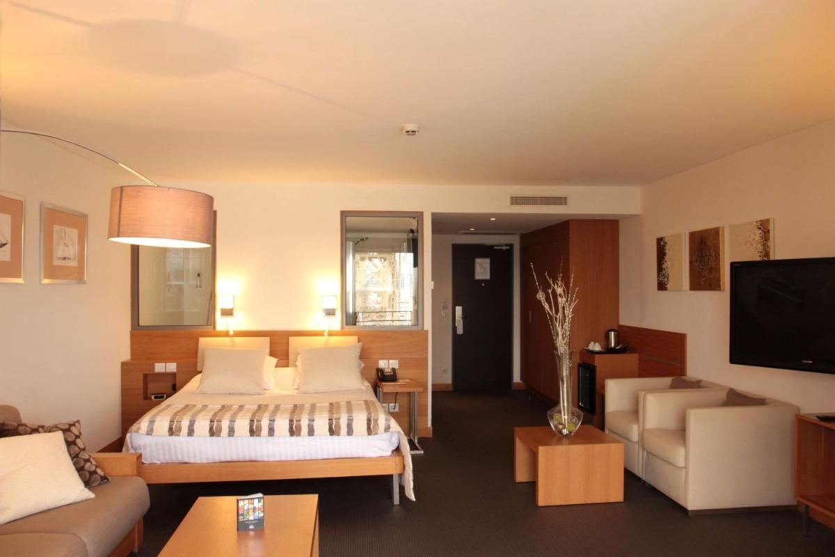 Un ou plusieurs lits dans un hébergement de l'établissement Best Western Premier Hôtel du Vieux-Port