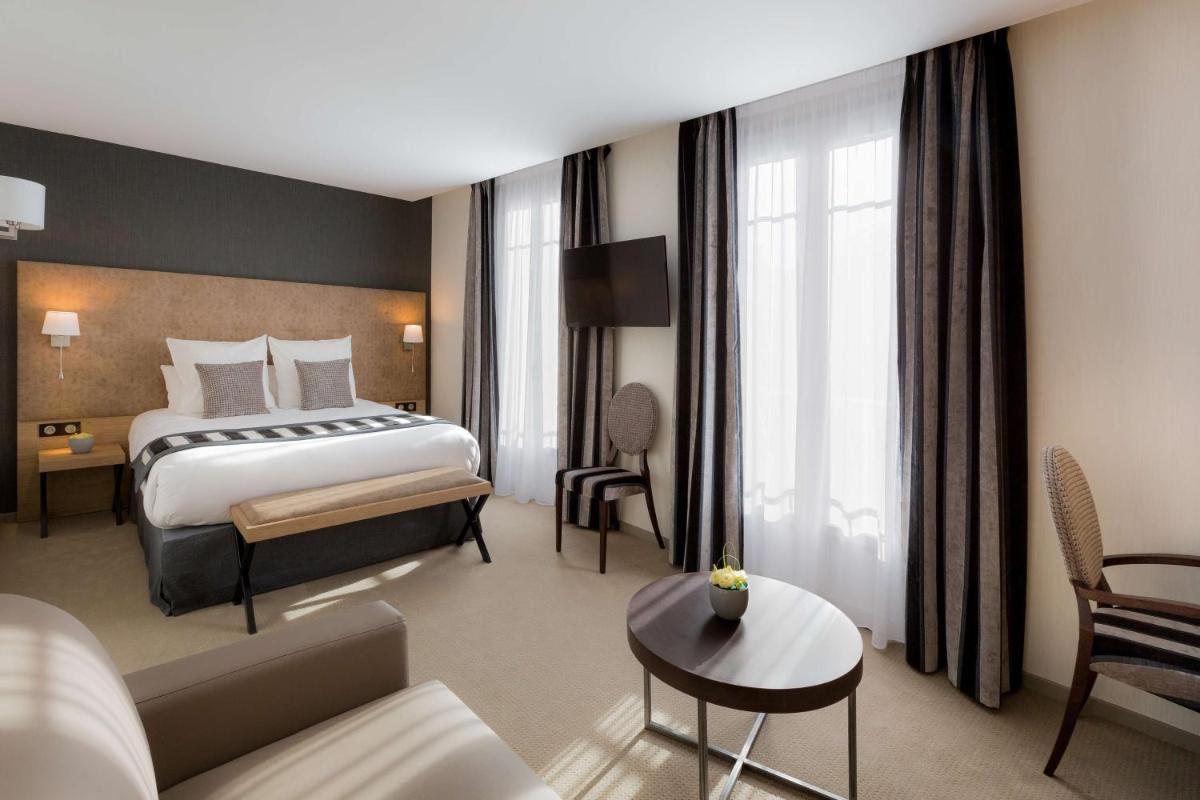 Un ou plusieurs lits dans un hébergement de l'établissement Hôtel Le Rive Droite & SPA