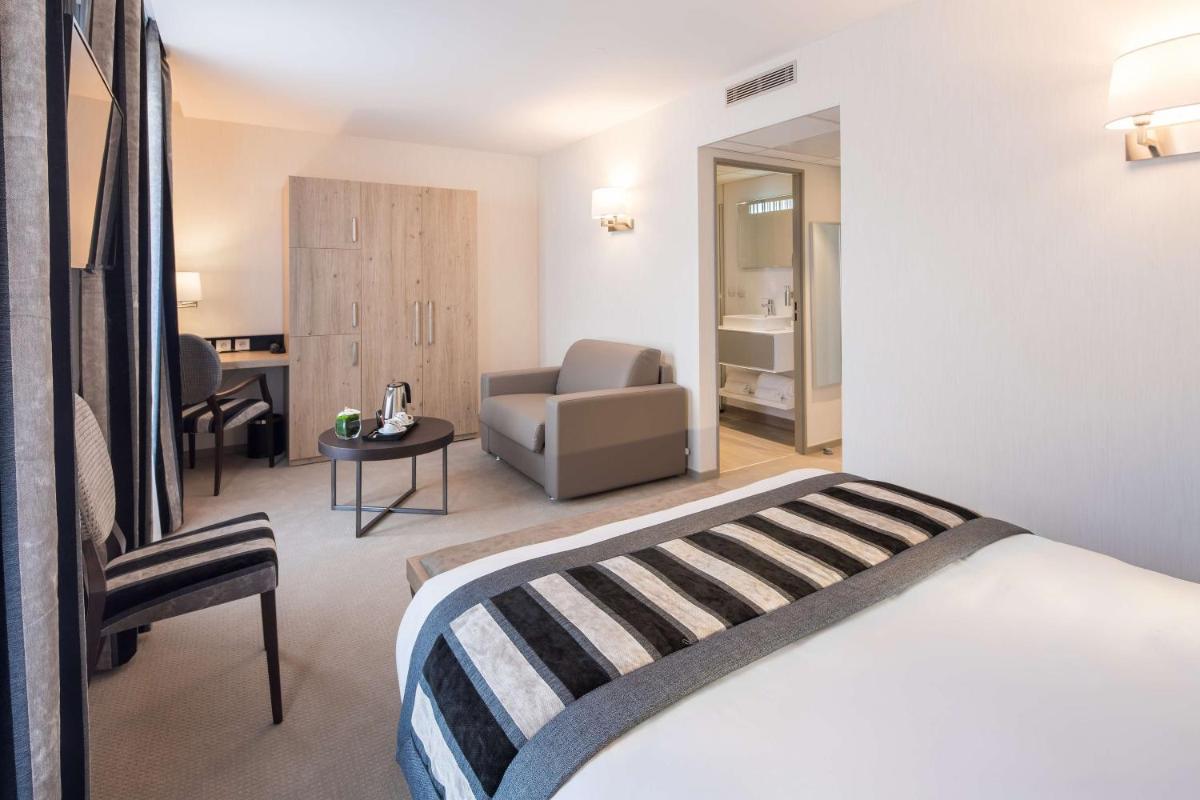 Un ou plusieurs lits dans un hébergement de l'établissement Hôtel Le Rive Droite & SPA