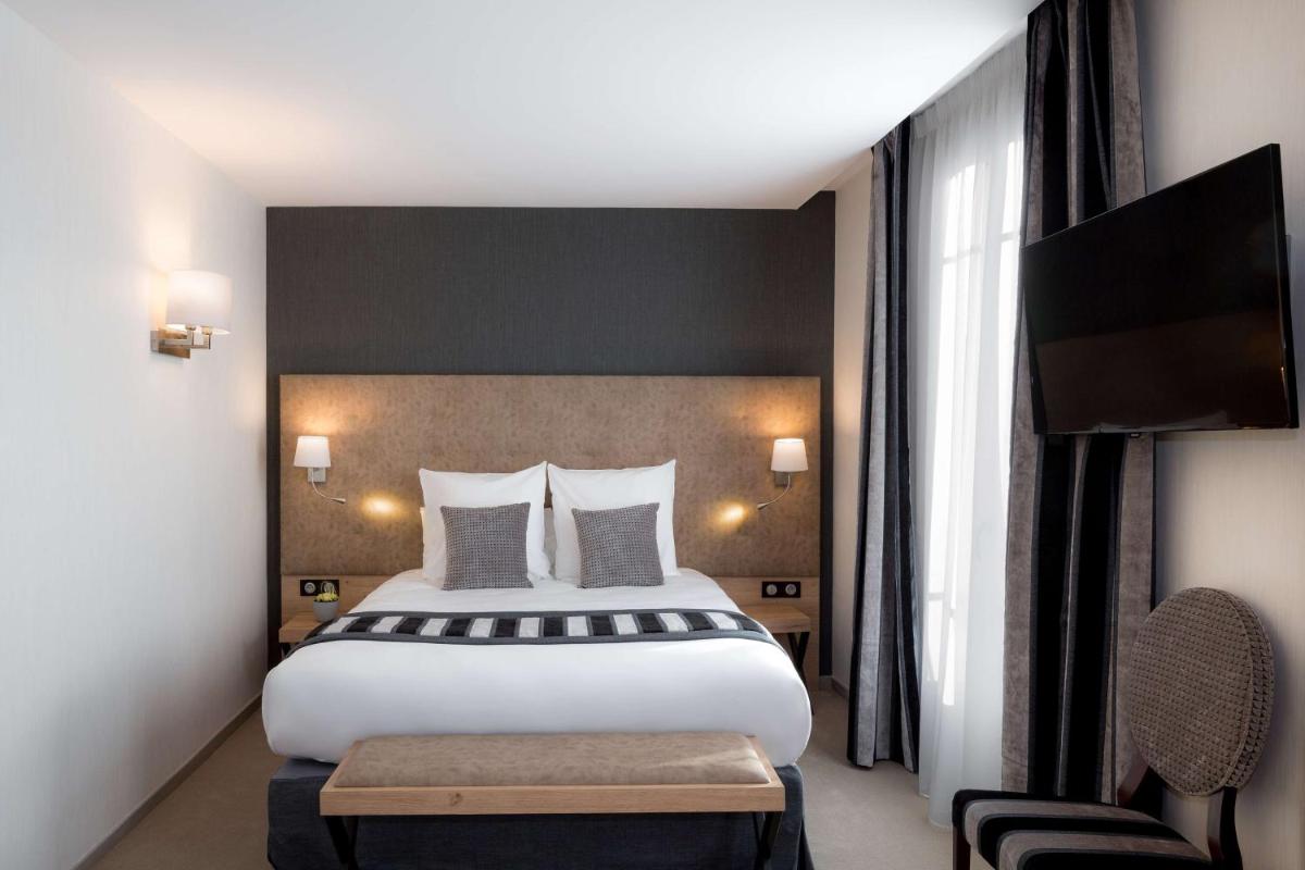 Un ou plusieurs lits dans un hébergement de l'établissement Hôtel Le Rive Droite & SPA