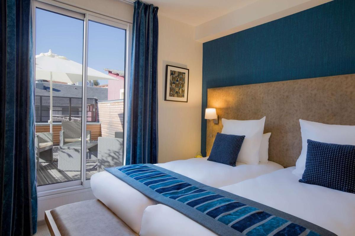 Un ou plusieurs lits dans un hébergement de l'établissement Hôtel Le Rive Droite & SPA