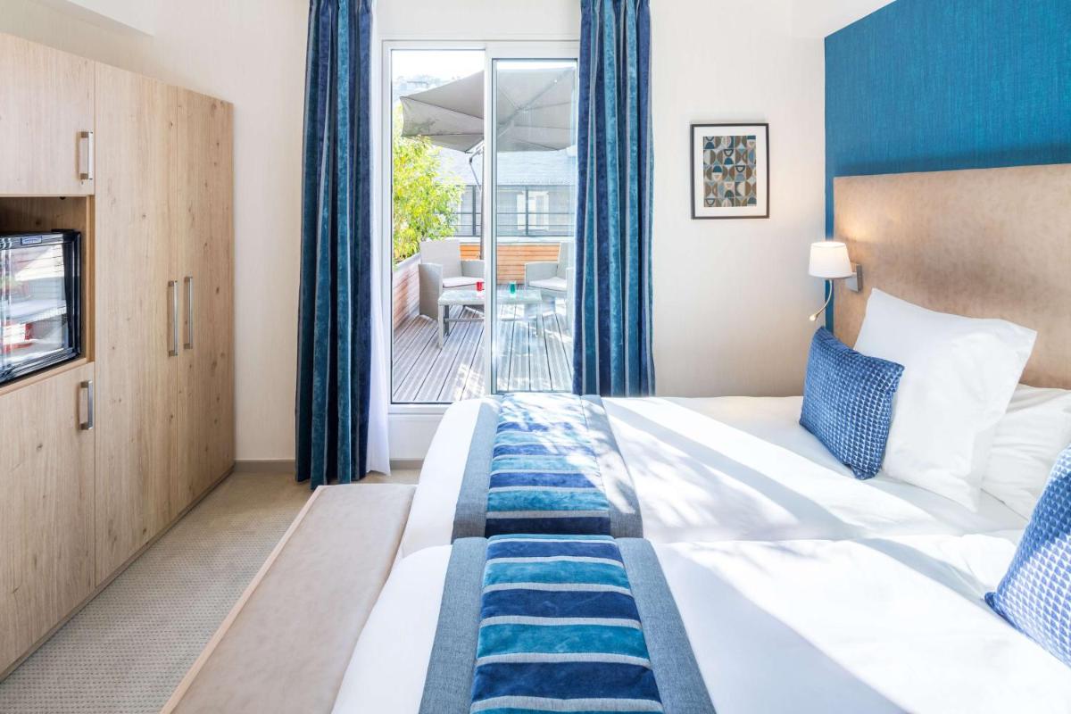 Un ou plusieurs lits dans un hébergement de l'établissement Hôtel Le Rive Droite & SPA