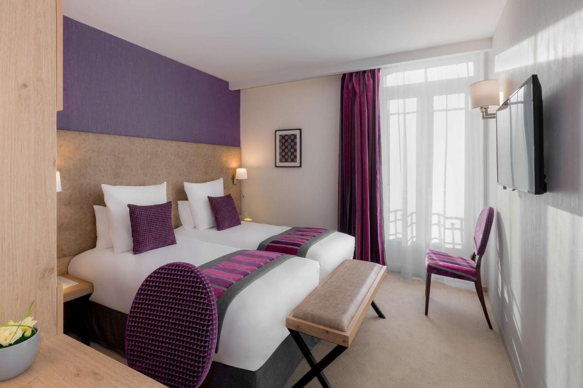 Un ou plusieurs lits dans un hébergement de l'établissement Hôtel Le Rive Droite & SPA
