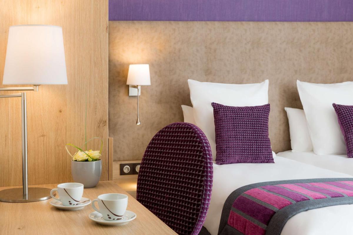 Un ou plusieurs lits dans un hébergement de l'établissement Hôtel Le Rive Droite & SPA