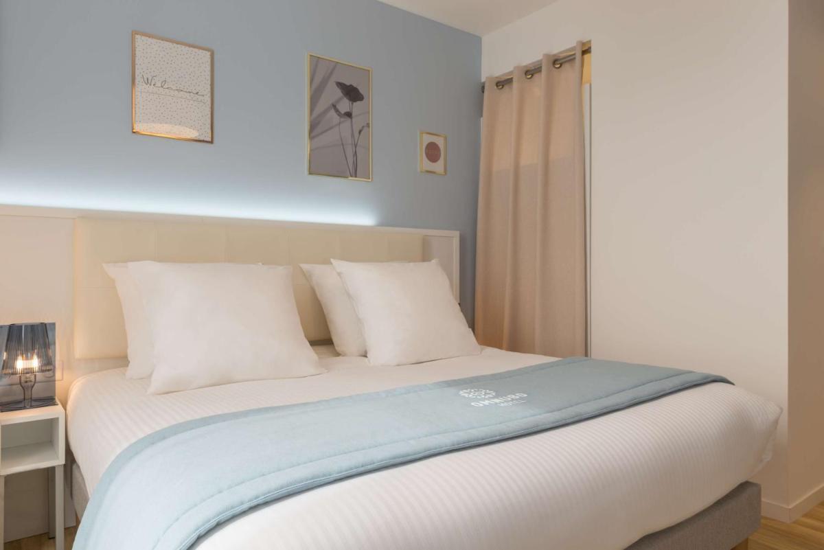 Un ou plusieurs lits dans un hébergement de l'établissement Hôtel Omnubo Collection