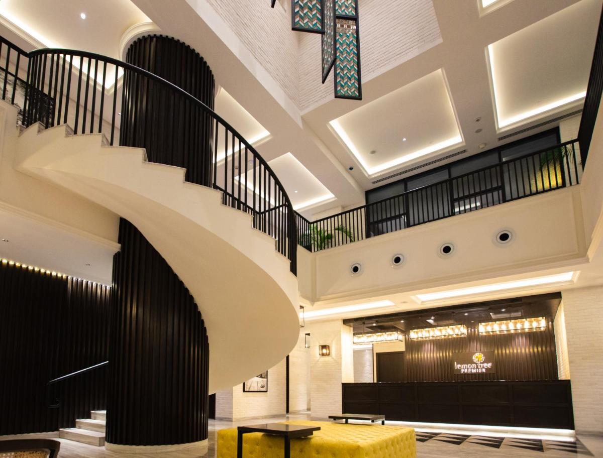 a spiral staircase in the lobby of a hotel at Lemon Tree Premier City Center Pune in Pune