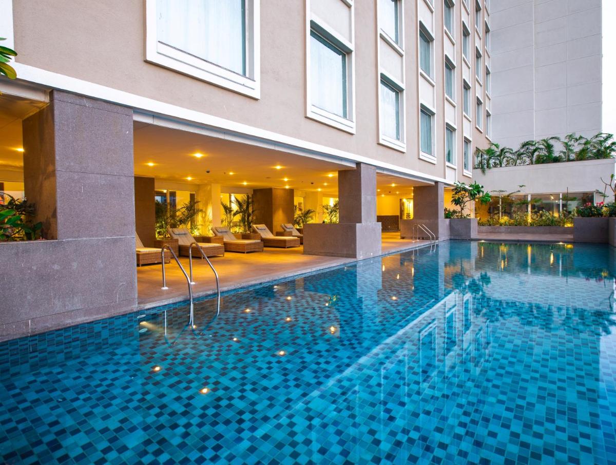 a swimming pool in the middle of a building at Lemon Tree Premier City Center Pune in Pune