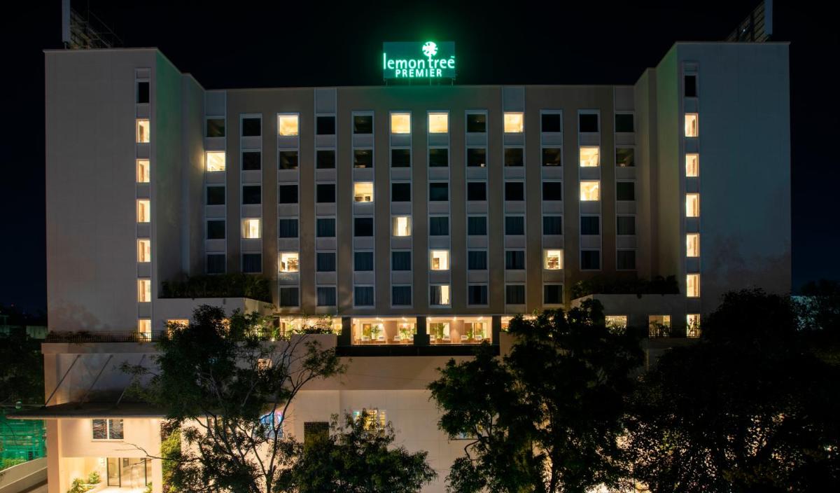 a building with a green sign on top of it at Lemon Tree Premier City Center Pune in Pune