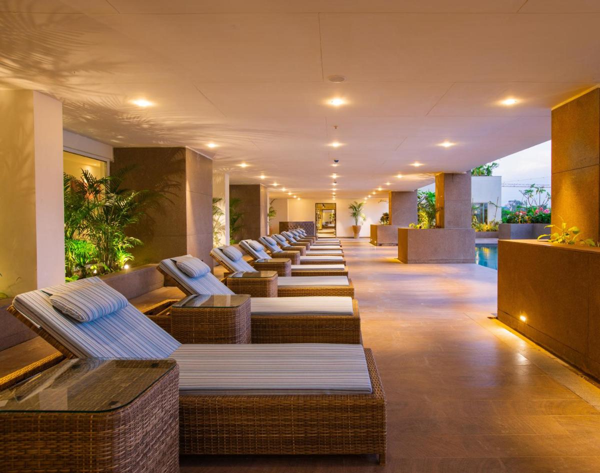 a row of lounge chairs in a hotel lobby at Lemon Tree Premier City Center Pune in Pune