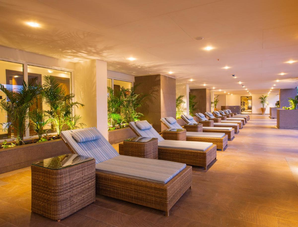 a row of wicker chairs in a hotel lobby at Lemon Tree Premier City Center Pune in Pune