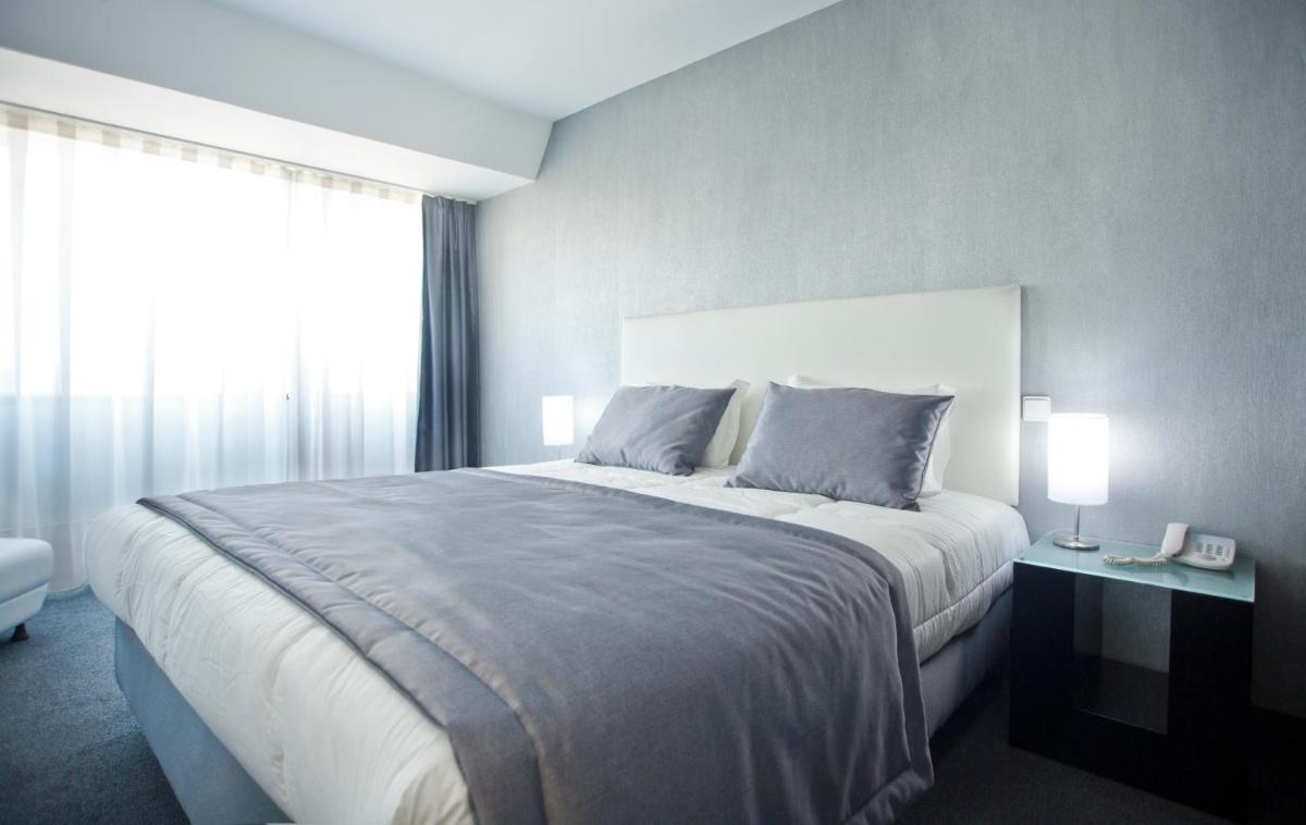 Uma cama ou camas num quarto em Miramar Hotel Spa & Apartments