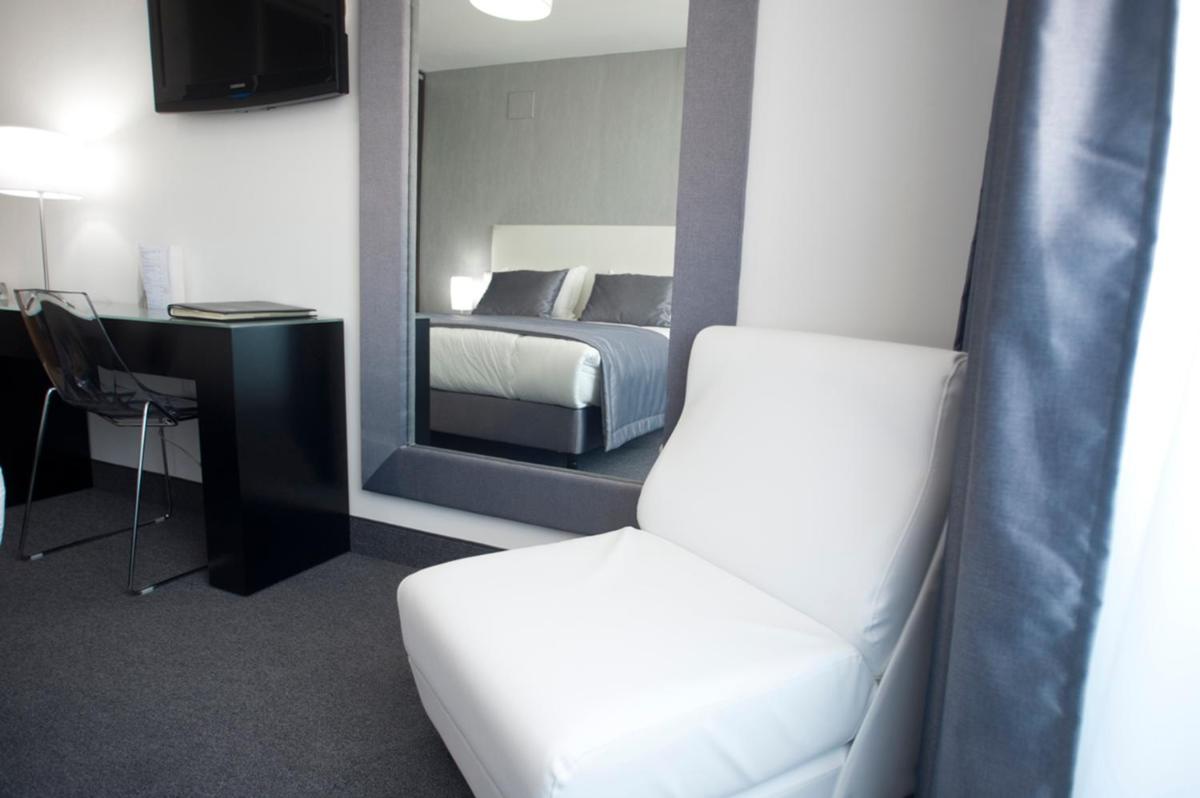 Uma cama ou camas num quarto em Miramar Hotel Spa & Apartments