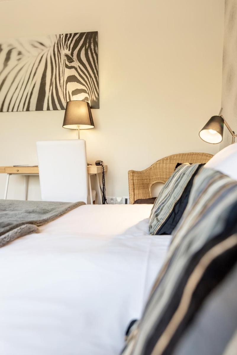 Un ou plusieurs lits dans un hébergement de l'établissement Carnac Lodge Hotel & Spa