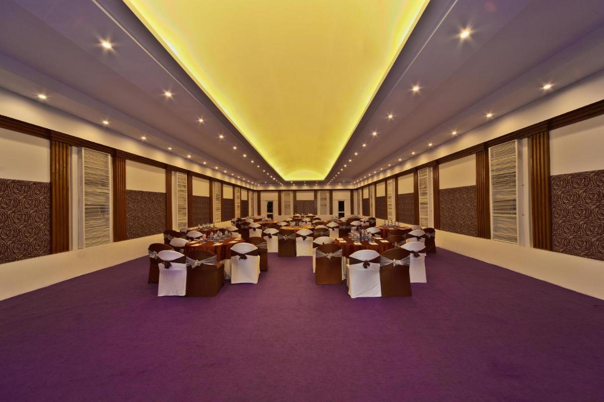 a large room with tables and chairs in it at Hotel Hindusthan International, Kolkata in Kolkata
